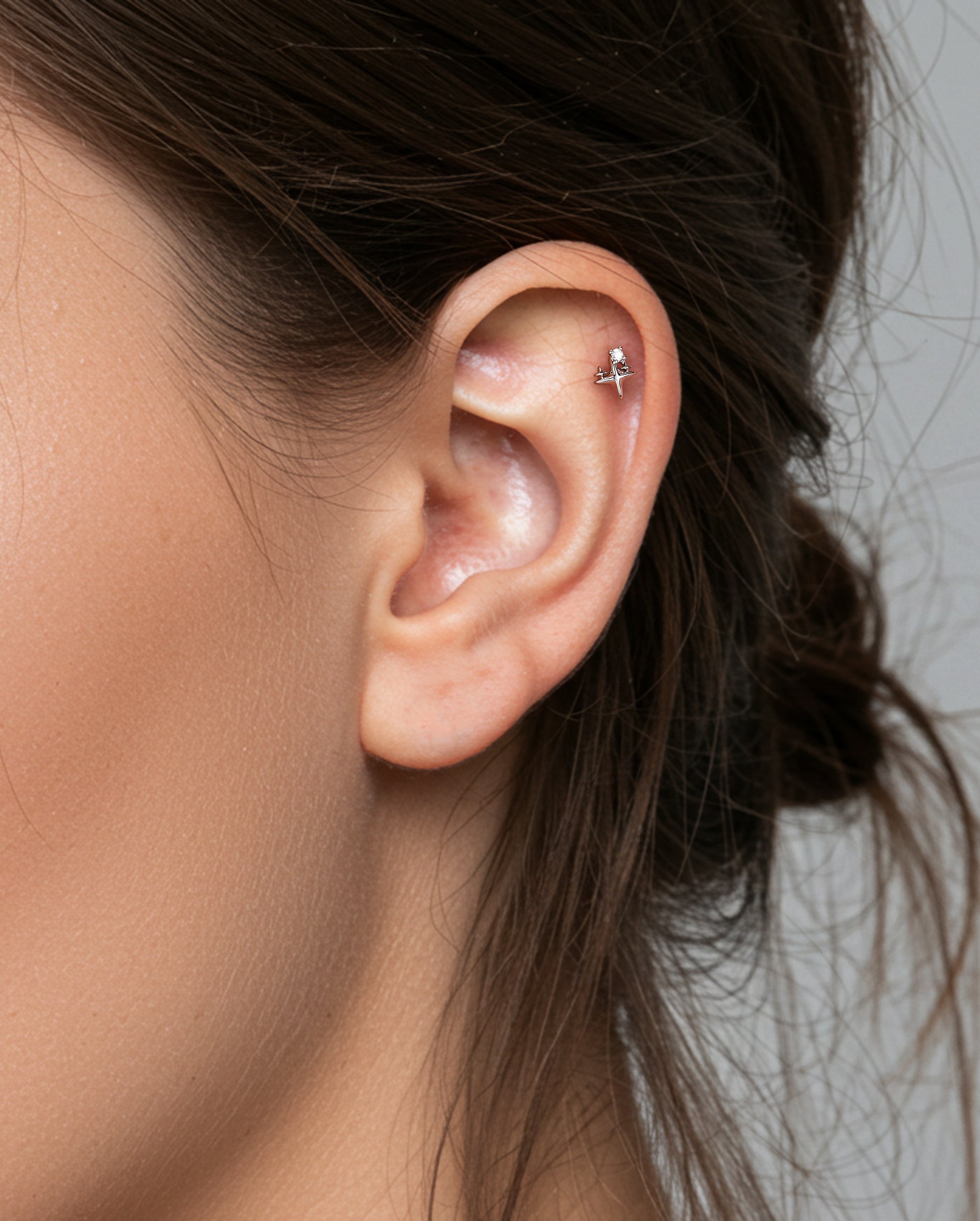gold starburst cartilage piercing